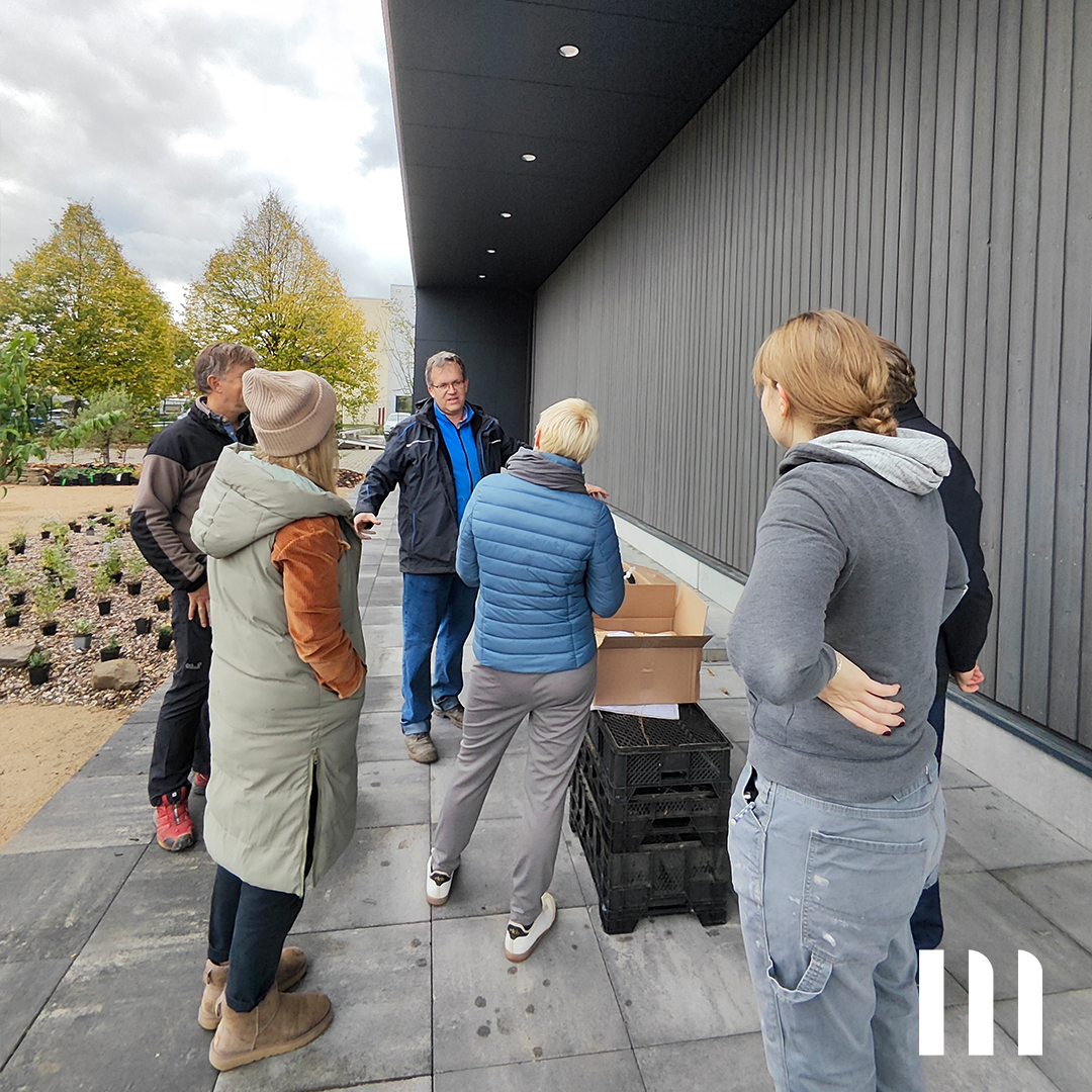 Mitarbeiter von ppm hören zu bei grüner Teamaktion